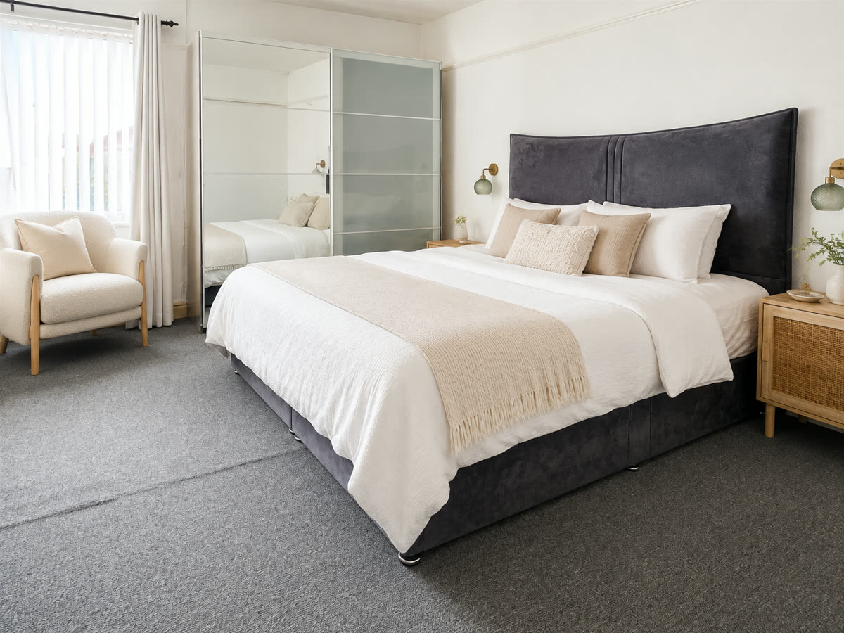 Double bedroom with mirrored wardrobes and a window to the side elevation